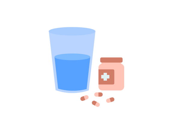 A cup of water and a bottle of pills