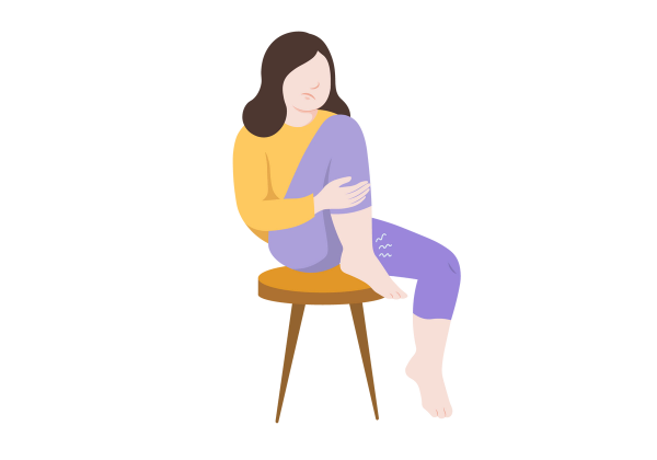 An illustration of a woman sitting on a stool with one foot on the floor and the other tucked against her chest with her heel on the stool. Her light peach-toned ankles are swollen, and three white squiggly lines come from the ankle resting on the stool. The frowning woman has medium length brown hair and is wearing a yellow sweatshirt and medium purple capri-length leggings.